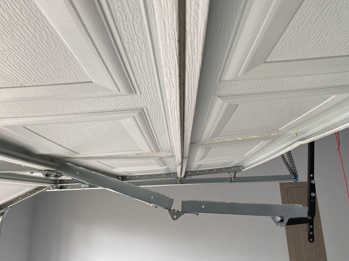 Damaged garage door panel needing replacement in El Paso
