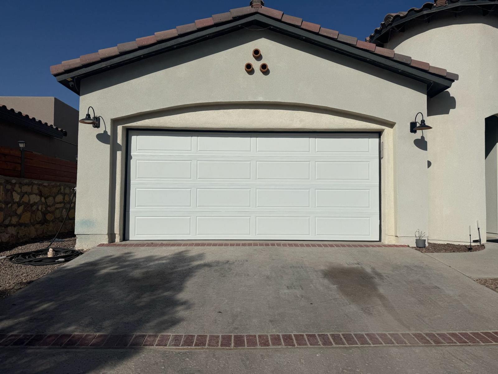 White sectional garage door on stucco home in El Paso