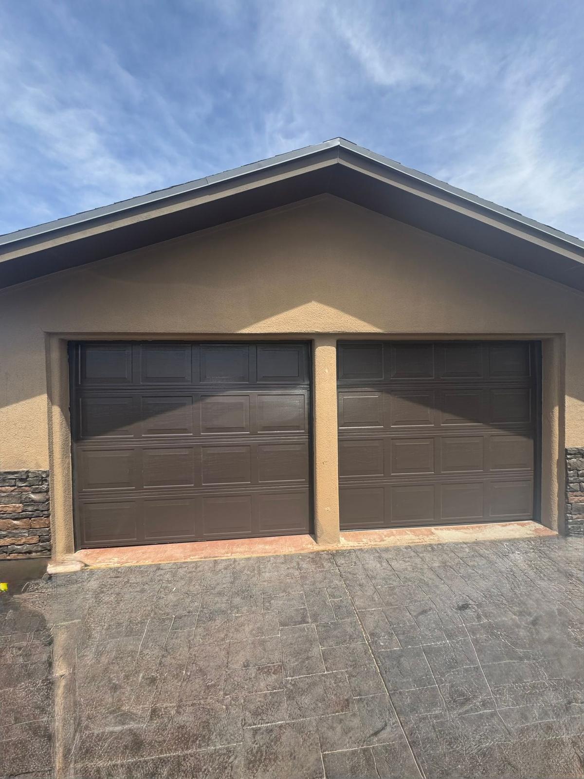 Bronze paneled residential garage doors installed in El Paso