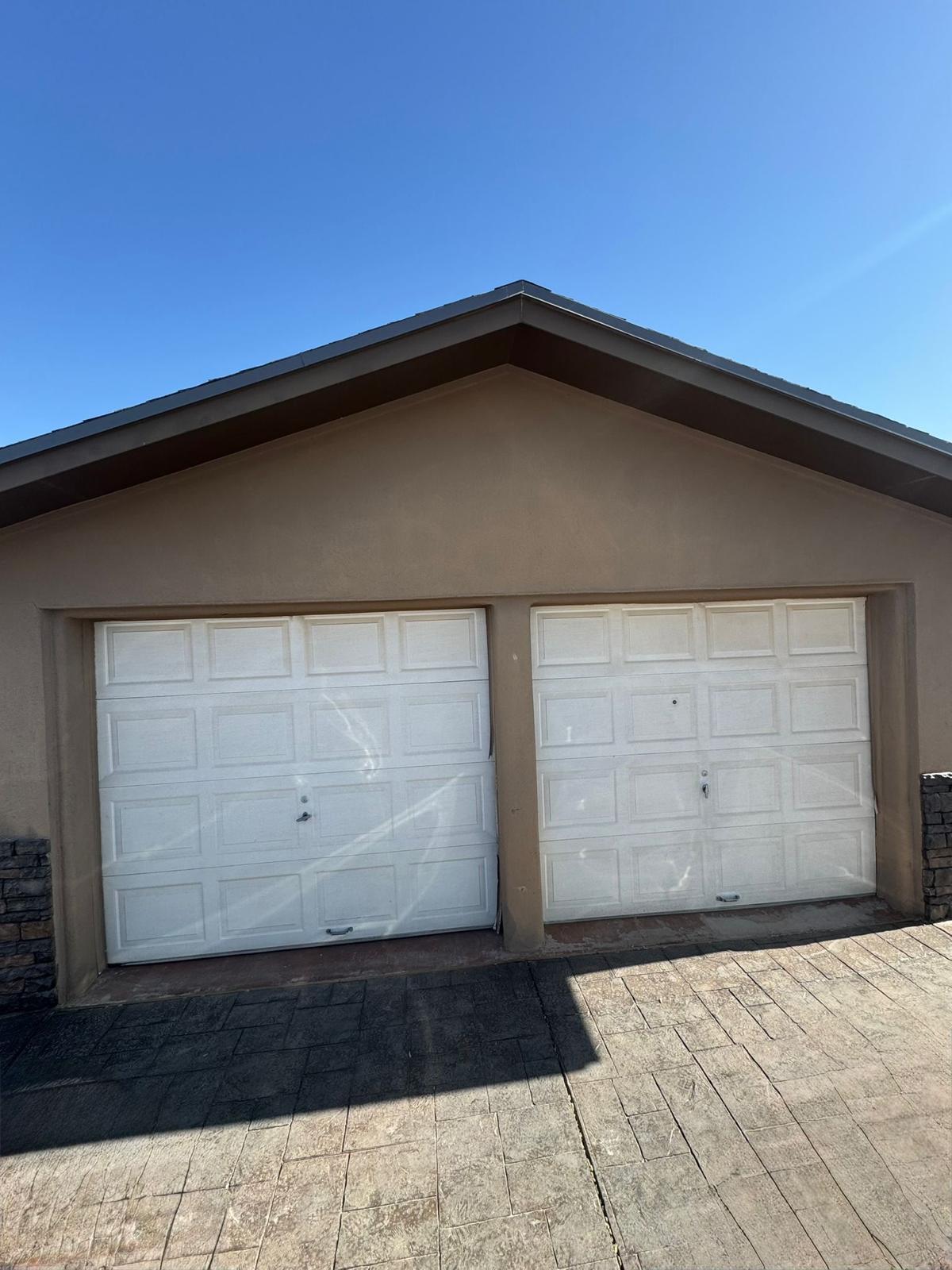 Classic white raised-panel residential garage doors